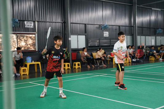 Junior badminton players on a badminton court