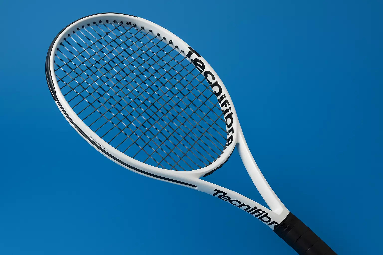 Tecnifibre tennis racket with Tecnifibre Razor Soft strings on a blue background