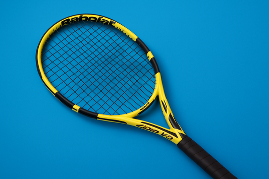 Babolat Pure Aero VS tennis racket with Babolat RPM Blast tennis strings in black on a blue background and anti clockwise rotation of the racket