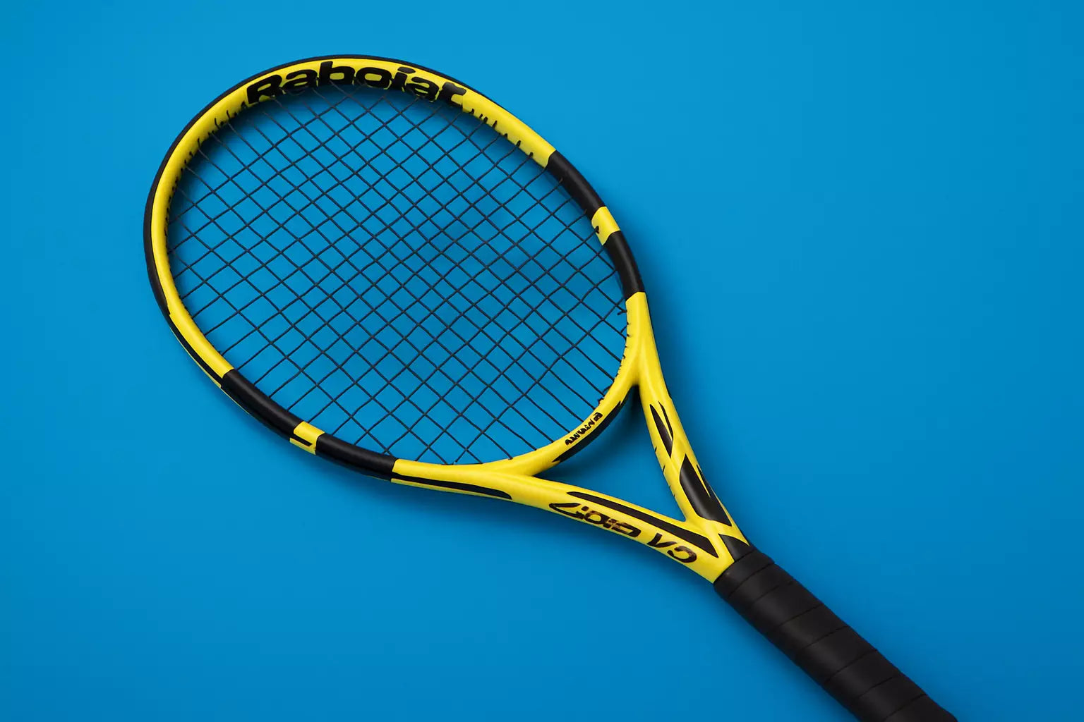 Babolat Pure Aero VS tennis racket with Babolat RPM Blast tennis strings in black on a blue background and anti clockwise rotation of the racket
