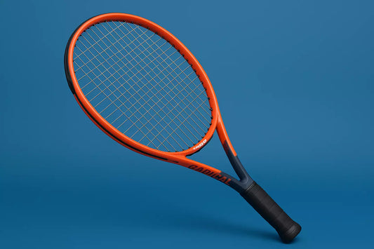 Head Radical tennis racket with RS Lyon strings in pearl grey on a blue background with an anti clockwise rotation of the racket