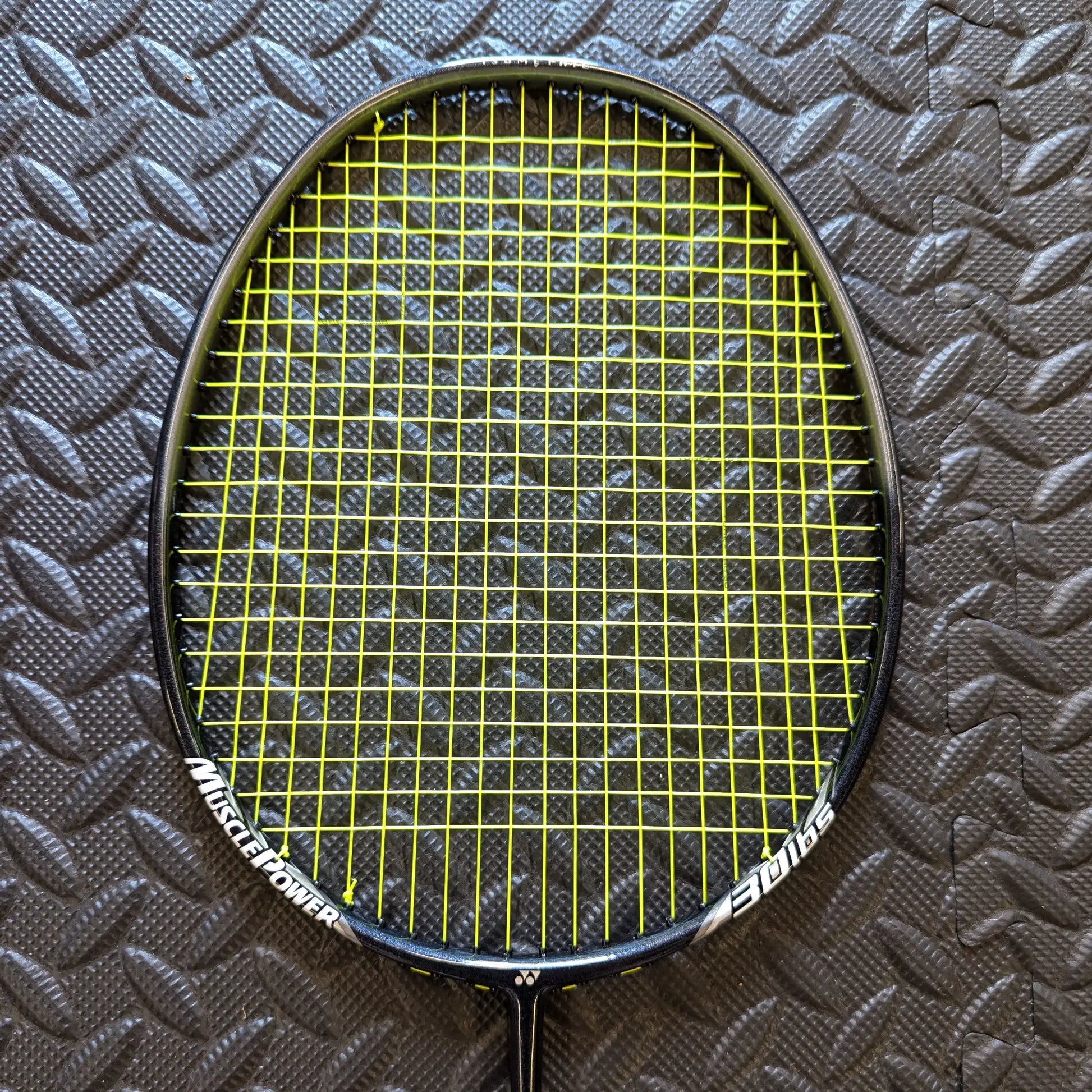 Yonex badminton racket restrung with Yonex BG80 string in yellow