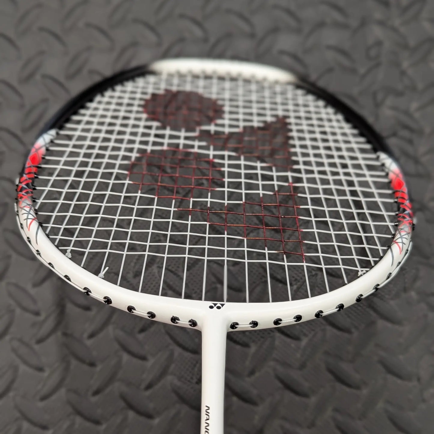 Yonex badminton racket with Yonex BG65 strings and a red Yonex stencil