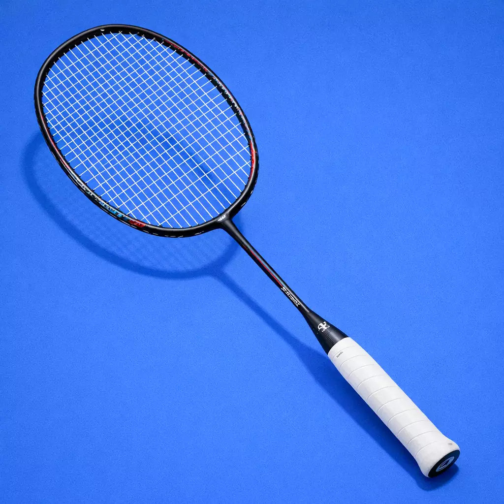 Badminton racket with a white handle and Yonex BG65 strings on a blue background