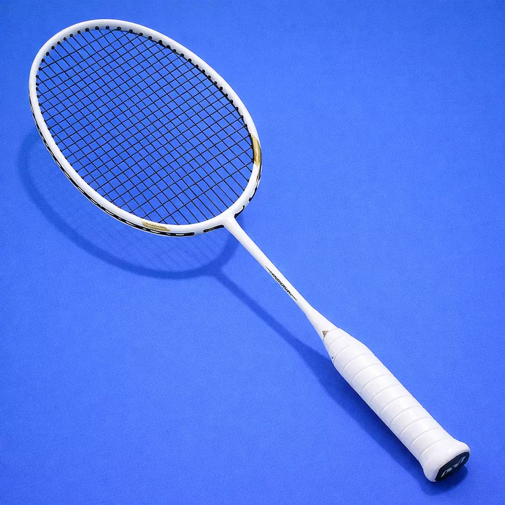 White badminton racket with Yonex BG66 Ultimax strings on a blue background