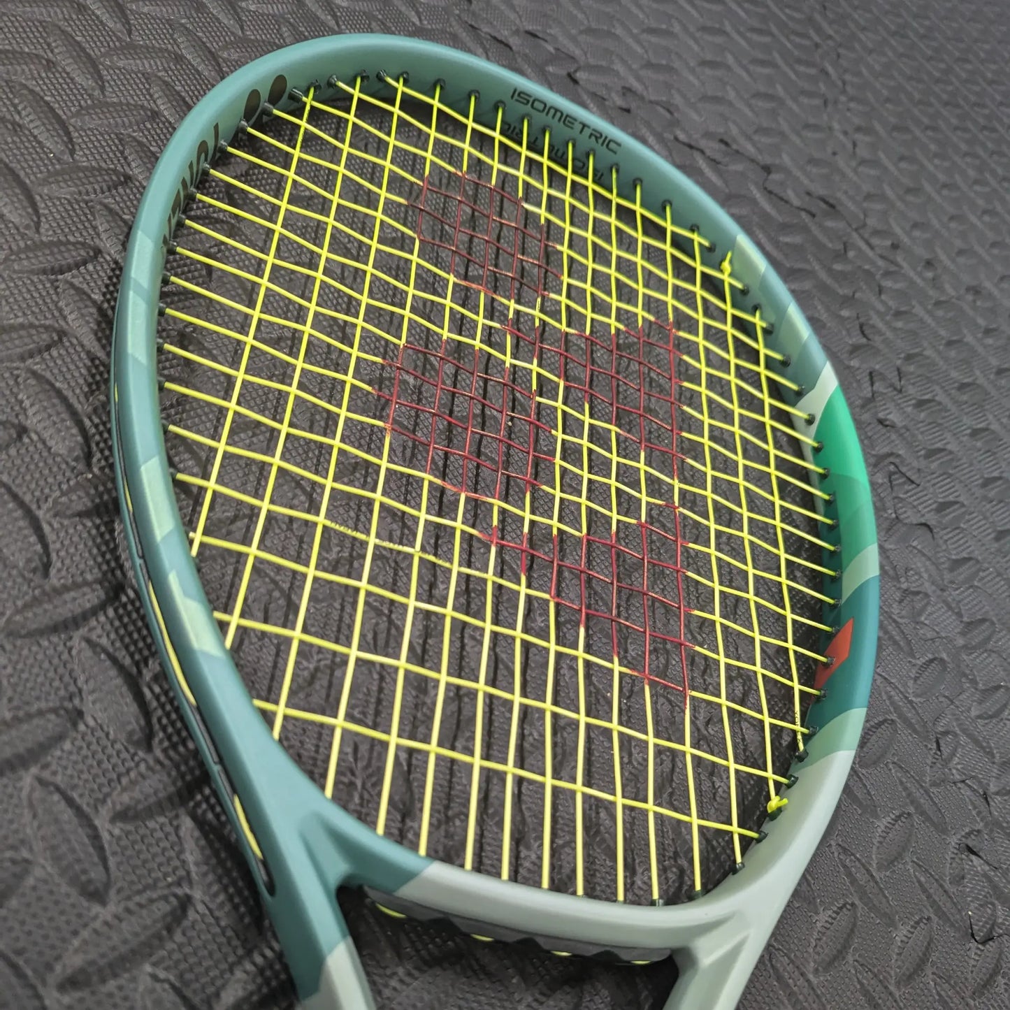 Yonex Percept tennis racket with Yonex Poly Tour Pro strings in yellow and a red Yonex stencil